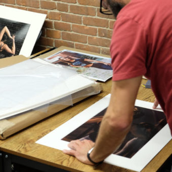 Artist mounting photographs